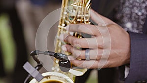 Close-up of a black man playing jazz on saxophone