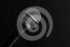 Close-up black microphone head isolated on black background