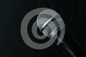 Close-up black microphone head isolated on black background