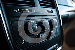 Close up black mini van interior, a/c dials