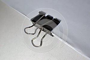 Close up of black paper clip, Bulldog clip for office stationery, Isolated on white background