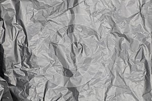 Close up of black plastic bag, The plastic surface is wrinkly and tattered making abstract pattern