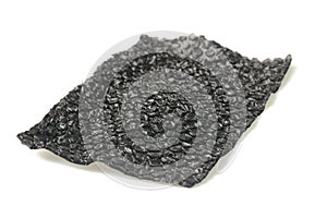 Close up of black plastic bubbles on a bubble wrap isolated by white background