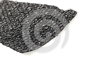Close up of black plastic bubbles on a bubble wrap isolated by white background