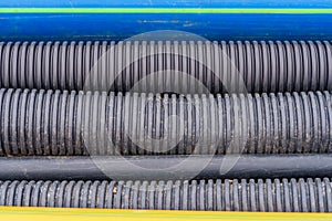 Close up of black plastic drainages, gas and water pipes in an excavation, photographed from above photo