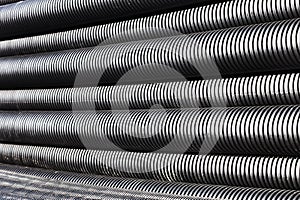 Close up of black plastic pipes with diminishing perspective