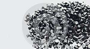 black plastic polymer granules on white background