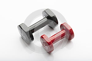 Close up of Black and Red  Colored Dumbbells Isolated on White Background