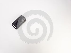 Close-up of a Black Remote Control on a Clean White Background