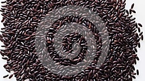 Close up of black rice grains scattered on white background, top view. Wild rice texture. Suitable for food and