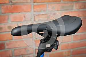 Close-up of a black saddle of a modern mountain bike. Outdoors