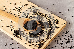 Close-up black sesame seeds in wooden spoon