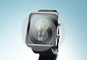 Close up of black smart watch with light bulb