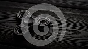 close up black spinner on a black background