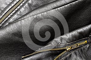 Close up of black stylish and fashion PU leather biker jacket texture with vintage copper-plated zipper with elements.