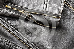 Close up of black stylish and fashion PU leather biker jacket texture with vintage copper-plated zipper with elements.