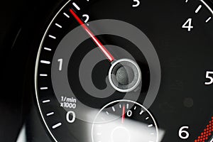 Close-up of a black tachometer in a car