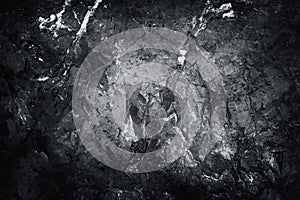 Close-up black and white worn textured stone surface background. Rock texture detail. .