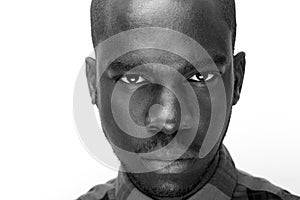 Close up black and white of young black man staring