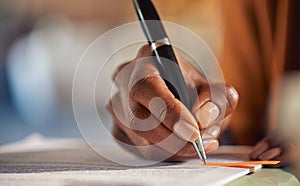 Close up of black woman hand writing on business document