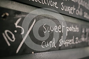 CLOSE UP of Blackboard wall with menu item