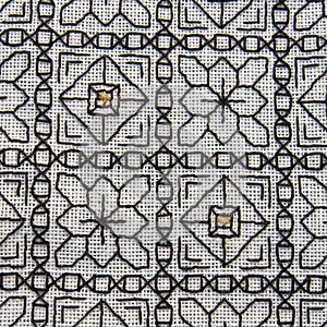Close-up of Blackwork embroidery with gold highlights photo