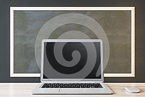 Close up of blank black laptop and mouse on chalkboard background, Education, seminar, workshop and mockup concept.