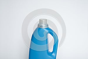 Close up blank blue plastic bottle with liquid laundry detergent, cleaning agent, bleach or fabric softener isolated on