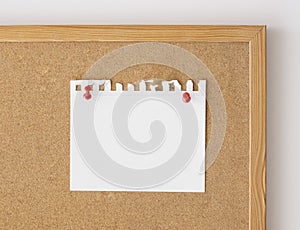 Close up blank paper sheet mockup pinned over board. Cork board background, front view