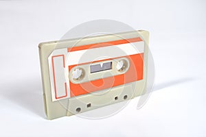 Close up of a blank vintage audio tape cassette isolated on white