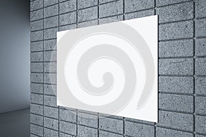 Close up of blank white underground banner on concrete tile wall on hallway background.