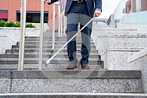 Close Up Of Blind Person Negotiating Steps Outdoors Using Cane