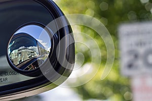 Close up of a blind spot mirror on the passenger side