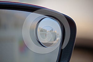 Close up of blind spot vehicle side mirror