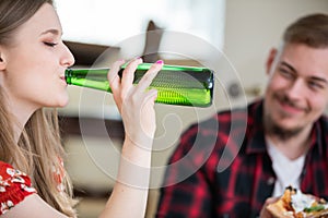 Close-up of a blonde woman drinking from a bottle