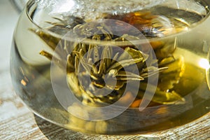 Close up of Blooming tea flower drowned in a tea jar