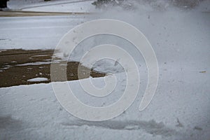 close-up of blowing snow on pavement driveway full frame abstract backdrop photo