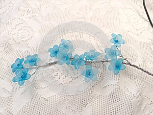 Close up blue artificial jasmine flowers on the white lace background