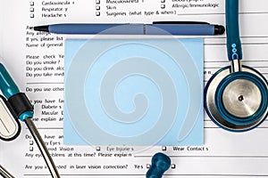 Close-up of a blue blank sheet that lies on the medical history among the pen stethoscope. The concept of health