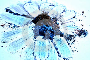 Close up of blue broken eyeshadows on a white surface photo