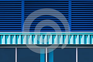 Close up of a blue bullding exterior with windows