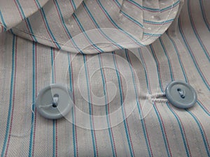 Close up of blue Buttons on a stripped blouse