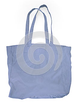Close up of blue canvas tote. Cotton cloth bag isolated on white background. Front view of Blank shopping sack with copy space.