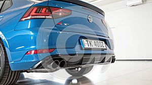 Close-up of blue car rear in white studio background.