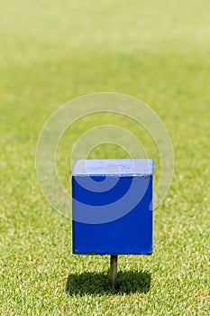 Close-up blue color wooden tee off area or tee box with blurred