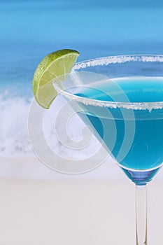 Close up Blue Curacao cocktail on the beach