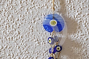 Blue evil eye beads on the wall