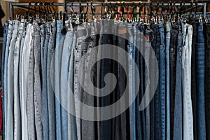 close-up, blue jeans on a hanger in a clothing store, sale of branded items, denim production department. background