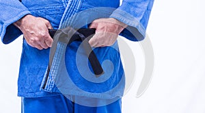 Close up of blue judo uniform, judo-gi, with belt isolated on white