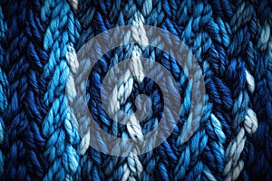 Close-up of blue knitted fabric texture with herringbone pattern